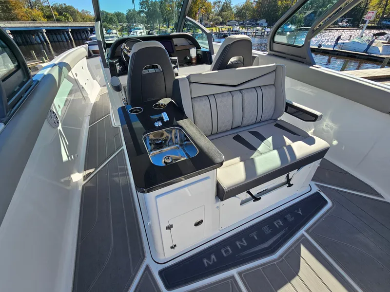 Slide: The Image of 2025 Monterey Elite 30 OB boat interior with sleek seating and modern amenities. - 22