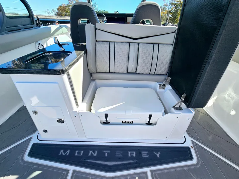 Slide: The Image of 2025 Monterey Elite 30 OB boat interior with seating and storage. - 23