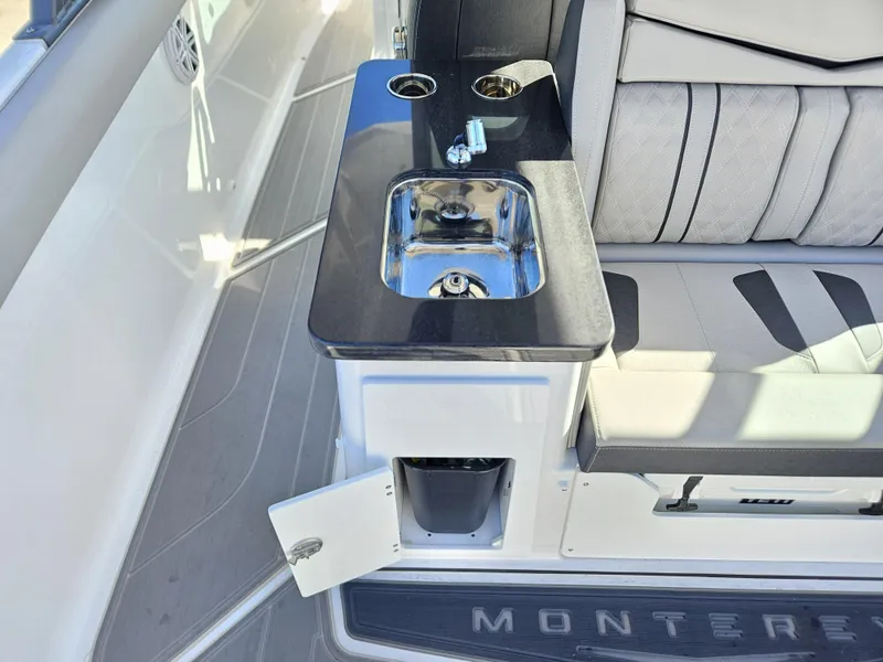 Slide: The Image of 2025 Monterey Elite 30 OB boat interior with sink and seating area. - 24