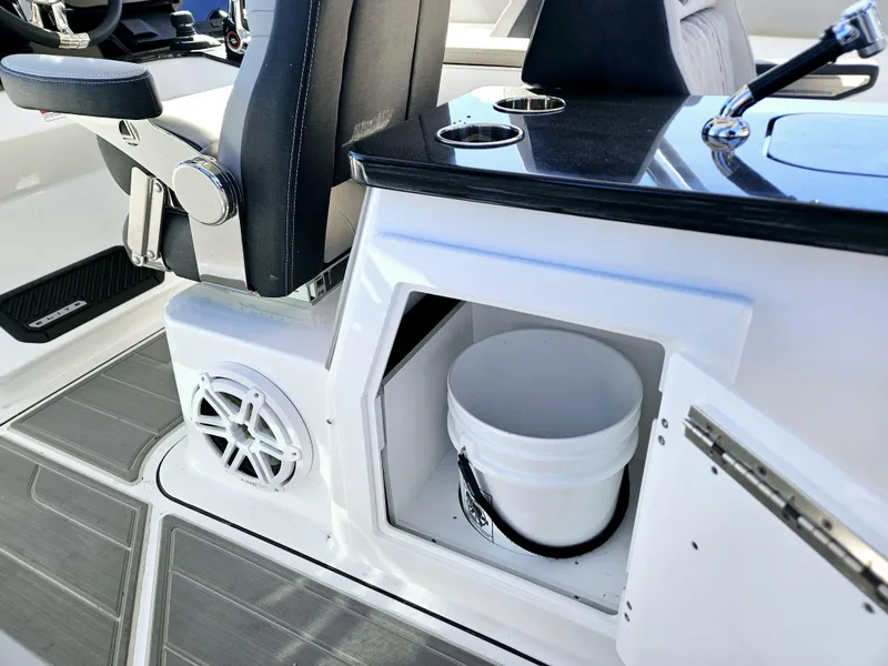 Slide: The Image of 2025 Monterey Elite 30 OB boat interior with storage compartment and bucket. - 25