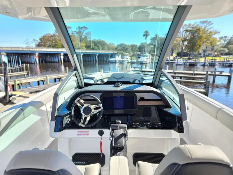 Slide: The Image of 2025 Monterey Elite 30 OB boat cockpit with modern steering and navigation system. - 27