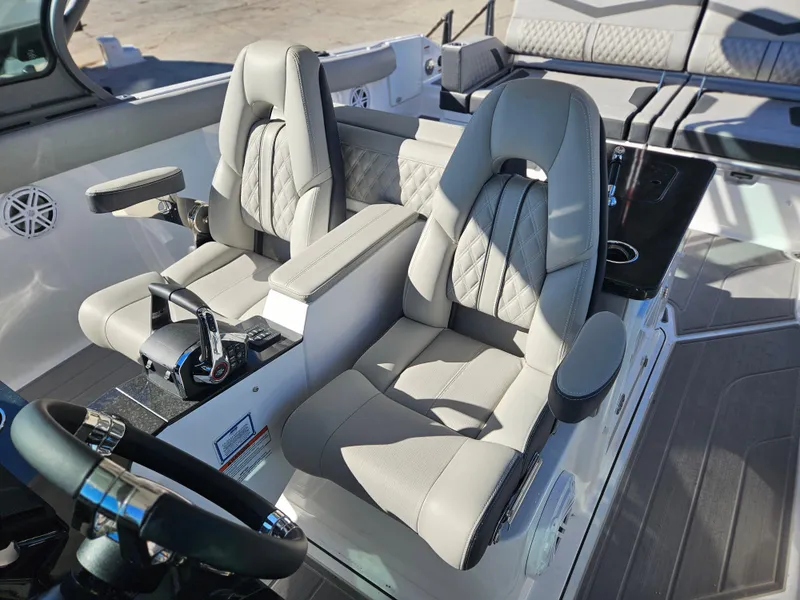 Slide: The Image of 2025 Monterey Elite 30 OB boat interior with luxurious seating and modern controls. - 28