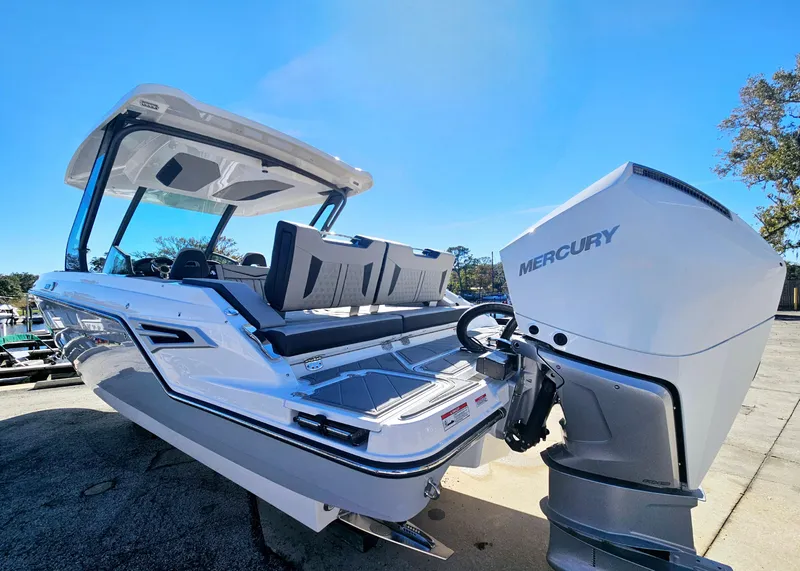 Slide: The Image of 2025 Monterey Elite 30 OB boat with Mercury outboard engine, docked under clear blue sky. - 3
