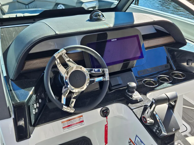 Slide: The Image of 2025 Monterey Elite 30 OB boat dashboard with modern controls and steering wheel. - 30