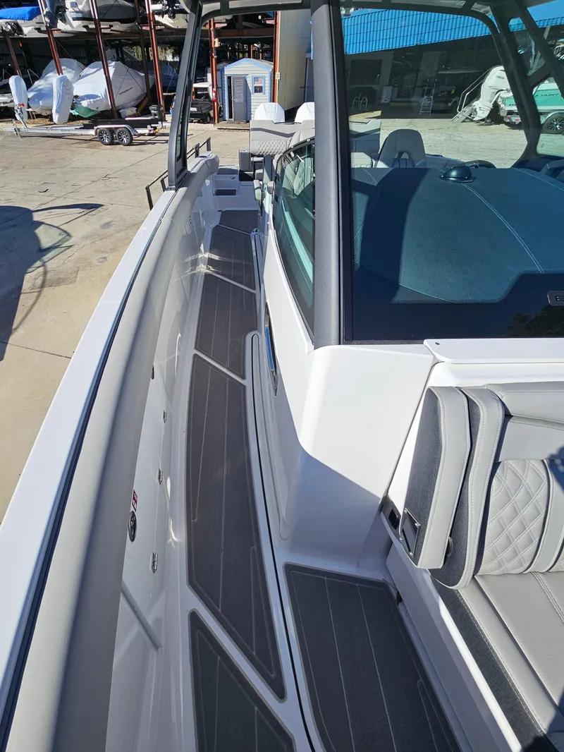 Slide: The Image of 2025 Monterey Elite 30 OB boat, sleek design, spacious deck, modern seating. - 34