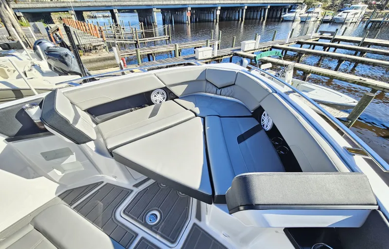 Slide: The Image of 2025 Monterey Elite 30 OB boat interior with sleek seating and waterfront view. - 38