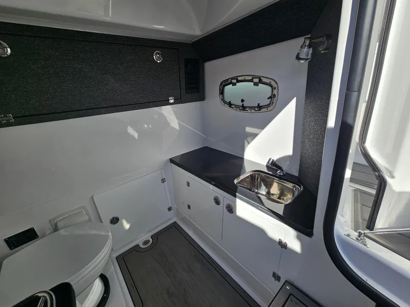 Slide: The Image of 2025 Monterey Elite 30 OB boat interior with sink and toilet. - 45
