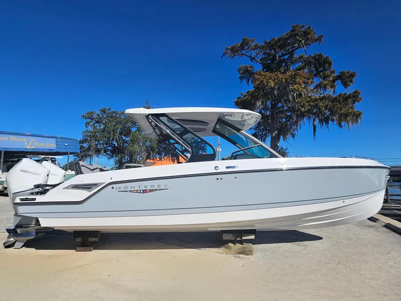 Slide: The Image of 2025 Monterey Elite 30 OB boat on display, sleek design, clear blue sky background. - 7