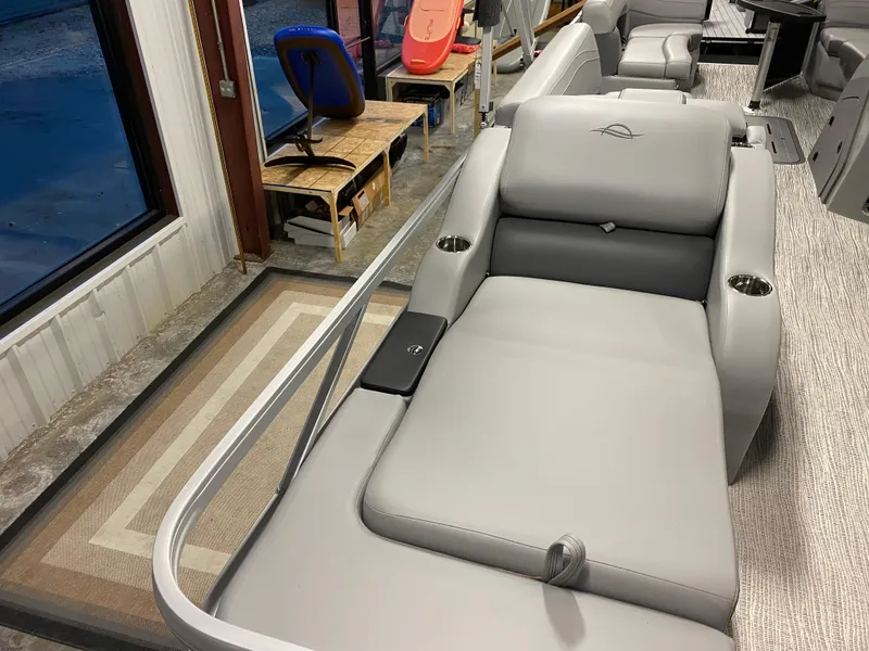 Slide: The Image of 2025 SunCatcher Fusion 324SS boat interior with gray seating and cup holders. - 10