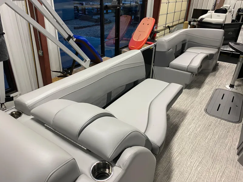 Slide: The Image of 2025 SunCatcher Fusion 324SS boat interior with sleek gray seating and cup holders. - 11