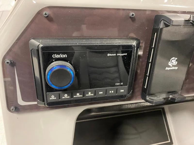 Slide: The Image of 2025 SunCatcher Fusion 324SS dashboard with Clarion audio system and AquaAmp holder. - 13