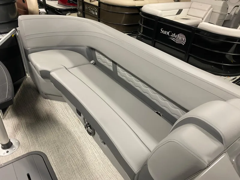 Slide: The Image of 2025 SunCatcher Fusion 324SS boat interior with sleek gray seating. - 14