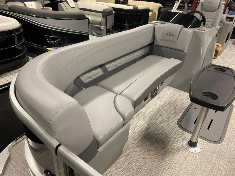 Slide: The Image of 2025 SunCatcher Fusion 324SS boat interior with sleek gray seating and modern design. - 19