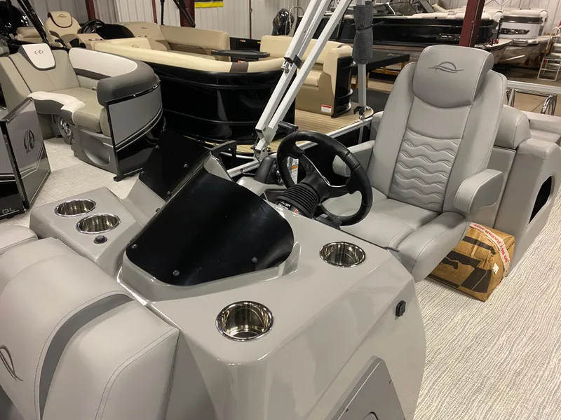 Slide: The Image of 2025 SunCatcher Fusion 324SS boat interior with steering wheel and seating. - 20