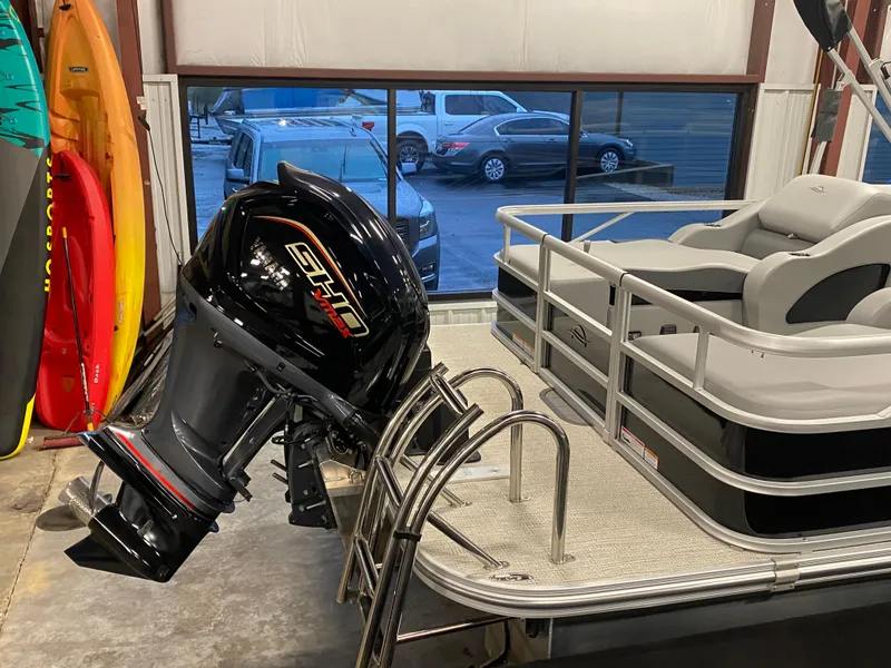 Slide: The Image of 2025 SunCatcher Fusion 324SS pontoon boat with powerful outboard motor in showroom. - 23