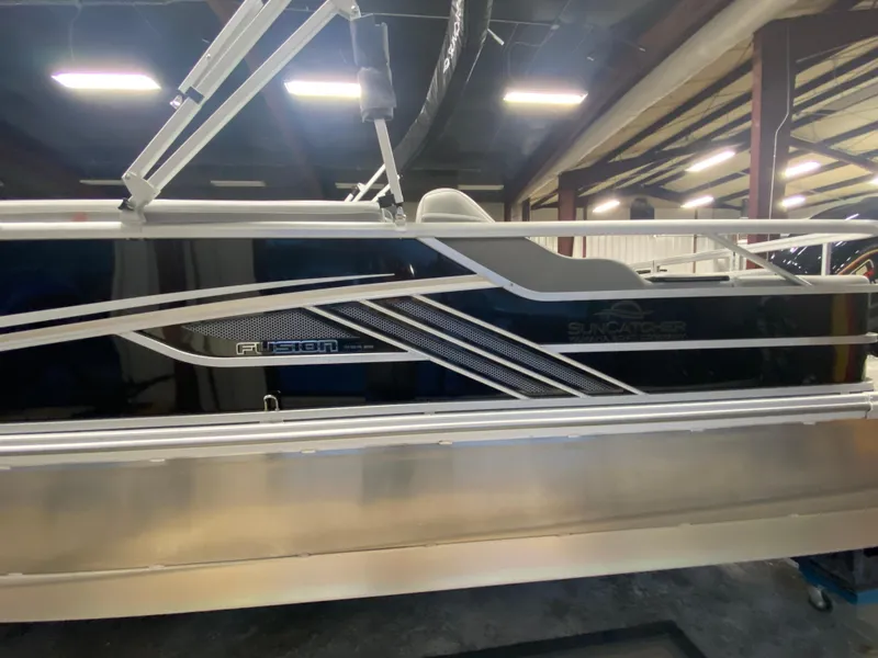 Slide: The Image of 2025 SunCatcher Fusion 324SS pontoon boat in a showroom setting. - 4