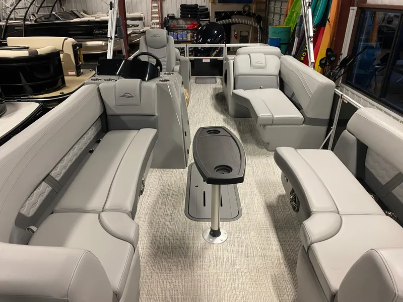 Slide: The Image of 2025 SunCatcher Fusion 324SS pontoon boat interior with spacious seating and modern design. - 5