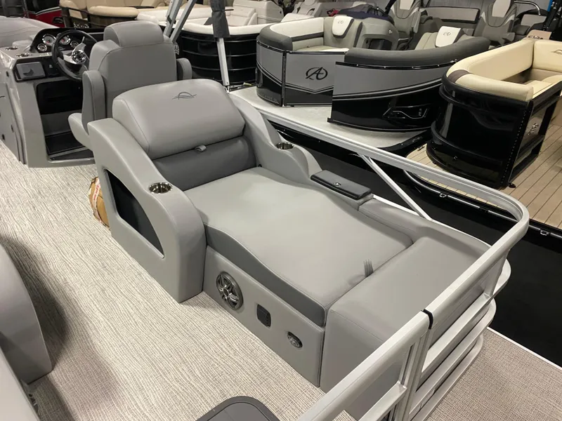 Slide: The Image of 2025 SunCatcher Fusion 324SS boat interior with luxurious gray seating and modern design. - 7
