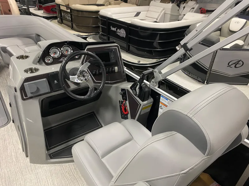 Slide: The Image of 2025 SunCatcher Fusion 324SS boat interior with steering wheel and seating. - 8