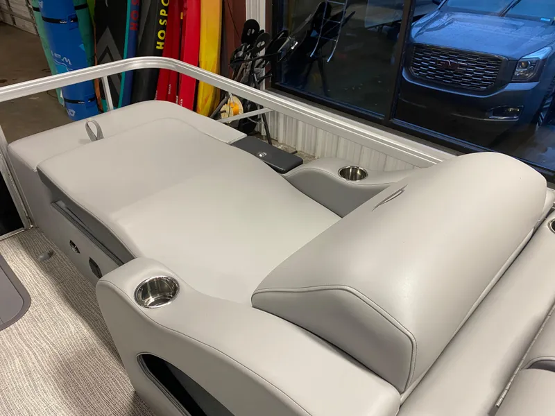 Slide: The Image of 2025 SunCatcher Fusion 324SS boat interior with sleek gray seating and cup holders. - 9