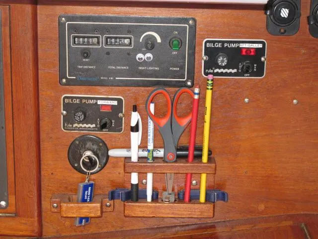 Slide: The Image of Control panel of a 1987 Pacific Seacraft PS37 with bilge pump switches and tools. - 12