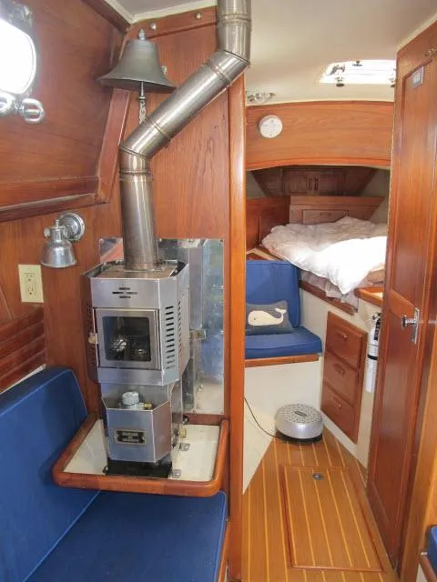 Slide: The Image of Interior of 1987 Pacific Seacraft PS37 sailboat with wood stove and cozy cabin. - 16