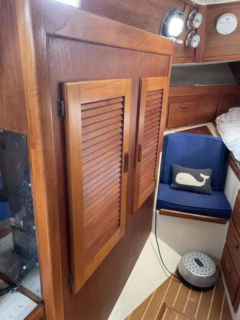 Slide: The Image of 1987 Pacific Seacraft PS37 interior with wooden cabinets and nautical decor. - 18