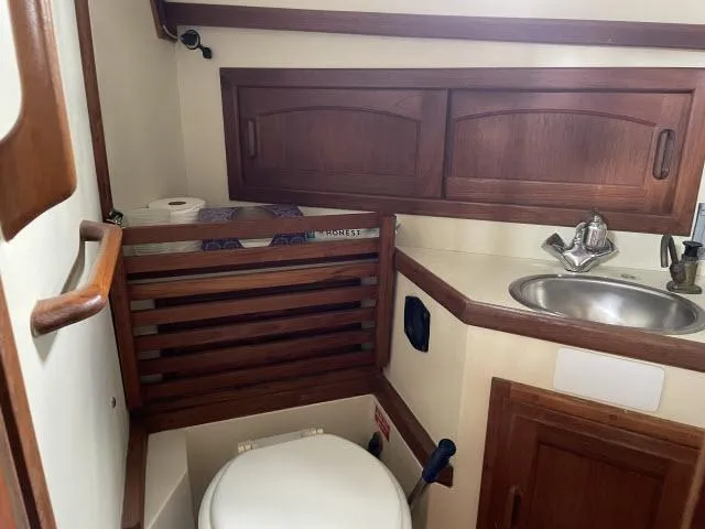 Slide: The Image of 1987 Pacific Seacraft PS37 yacht bathroom with wooden cabinets and compact sink. - 19