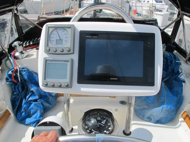 Slide: The Image of 1987 Pacific Seacraft PS37 yacht cockpit with navigation instruments and compass. - 23