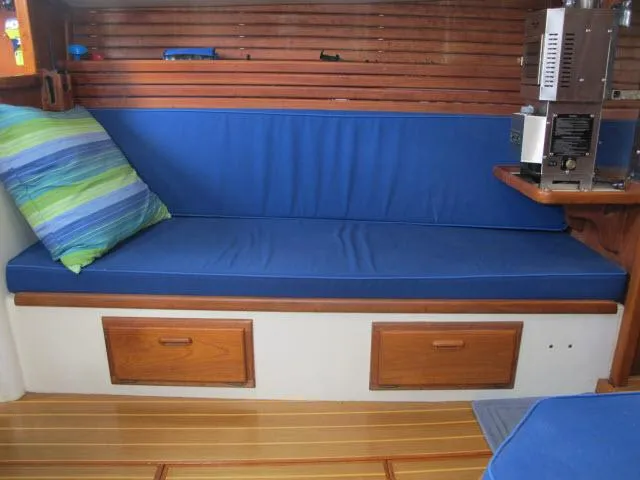 Slide: The Image of Blue cushioned seating area in 1987 Pacific Seacraft PS37 sailboat interior. - 3