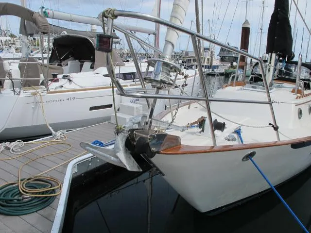 Slide: The Image of 1987 Pacific Seacraft PS37 sailboat docked at marina, surrounded by other vessels. - 32