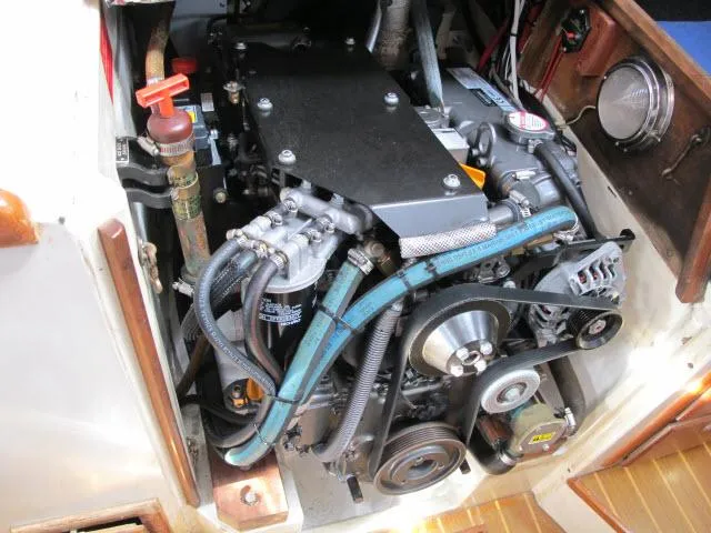 Slide: The Image of Engine compartment of a 1987 Pacific Seacraft PS37 sailboat, showcasing detailed mechanical components. - 36