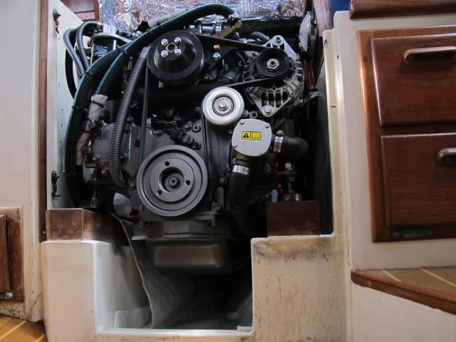 Slide: The Image of Engine compartment of a 1987 Pacific Seacraft PS37 sailboat, showcasing detailed mechanics. - 37