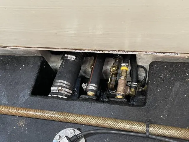 Slide: The Image of Engine compartment of 1987 Pacific Seacraft PS37 with visible hoses and fittings. - 39