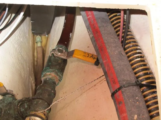 Slide: The Image of Close-up of 1987 Pacific Seacraft PS37 plumbing with corroded valve and hoses. - 41