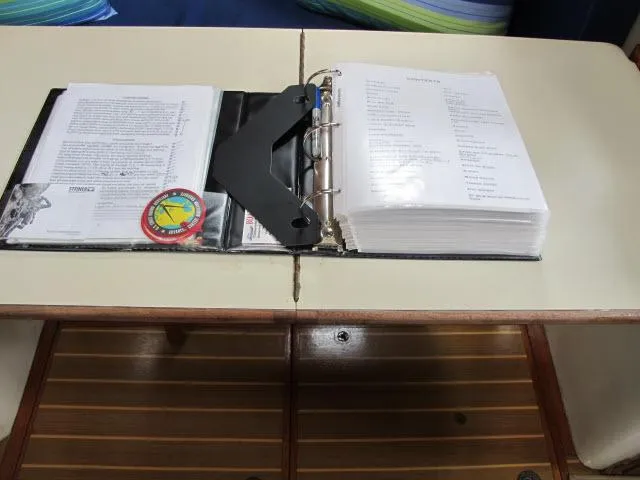 Slide: The Image of Open binder with documents on a Pacific Seacraft PS37 sailboat table, 1987 model. - 42