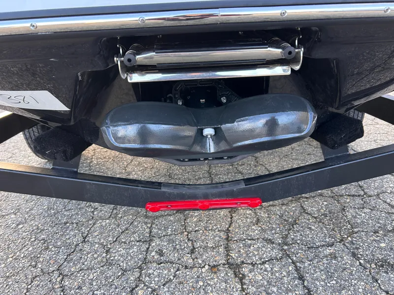 Slide: The Image of 2025 Scarab 165 LX boat trailer hitch and rear view on pavement. - 12