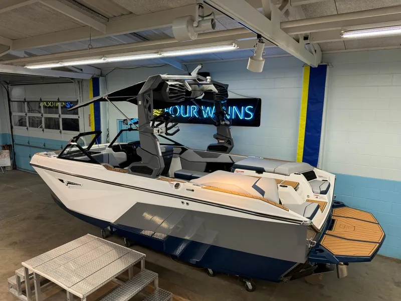 Slide: The Image of 2025 Nautique Super Air Nautique S21 boat in showroom, sleek design, modern features. - 10