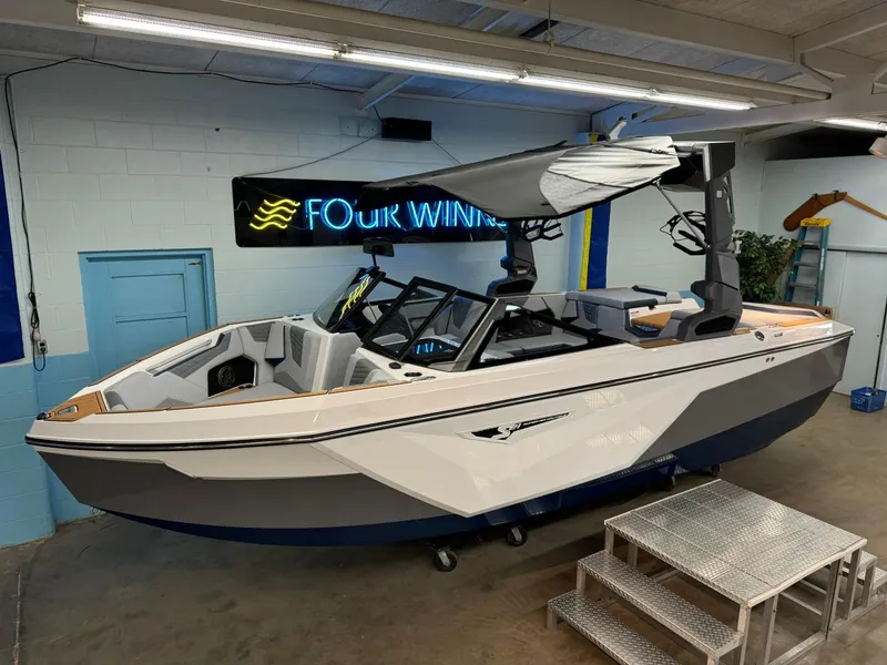 Slide: The Image of 2025 Nautique Super Air Nautique S21 boat displayed indoors with canopy. - 11