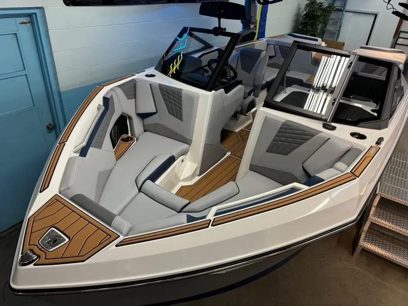 Slide: The Image of 2025 Nautique Super Air Nautique S21 boat interior with sleek seating and modern design. - 12