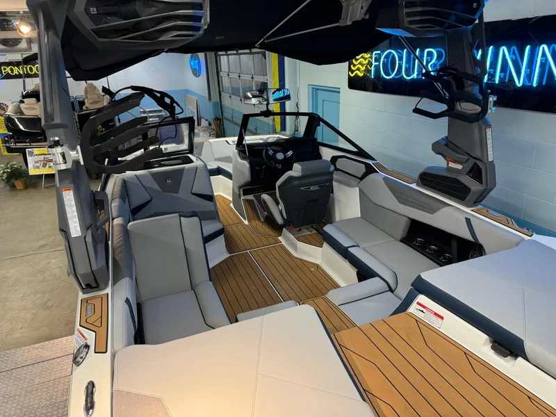 Slide: The Image of 2025 Nautique Super Air Nautique S21 interior with sleek seating and modern dashboard. - 14