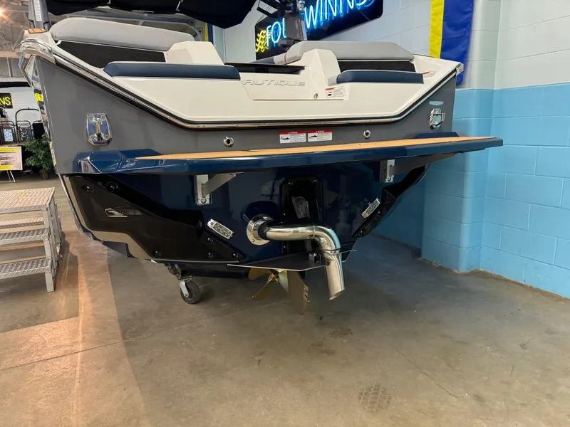 Slide: The Image of 2025 Nautique Super Air Nautique S21 boat rear view in showroom. - 15
