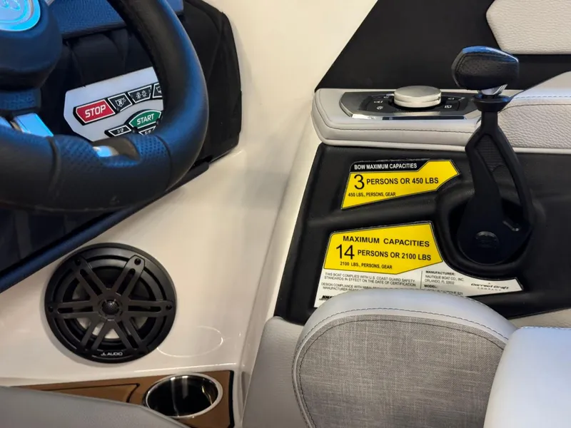 Slide: The Image of 2025 Nautique Super Air Nautique S21 dashboard with capacity labels and controls. - 17