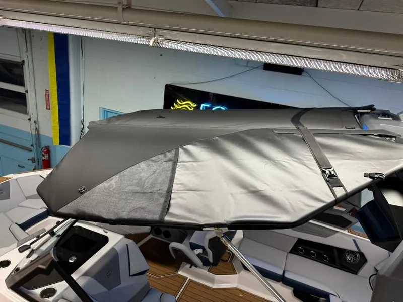 Slide: The Image of 2025 Nautique Super Air Nautique S21 boat interior with protective cover. - 21