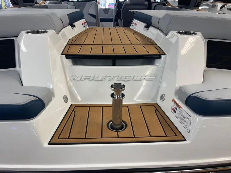 Slide: The Image of 2025 Nautique Super Air Nautique S21 boat interior with teak decking and seating. - 24