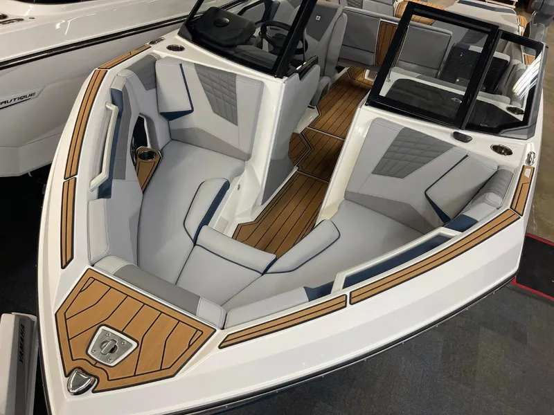 Slide: The Image of 2025 Nautique Super Air Nautique S21 boat interior with sleek seating and wood accents. - 25
