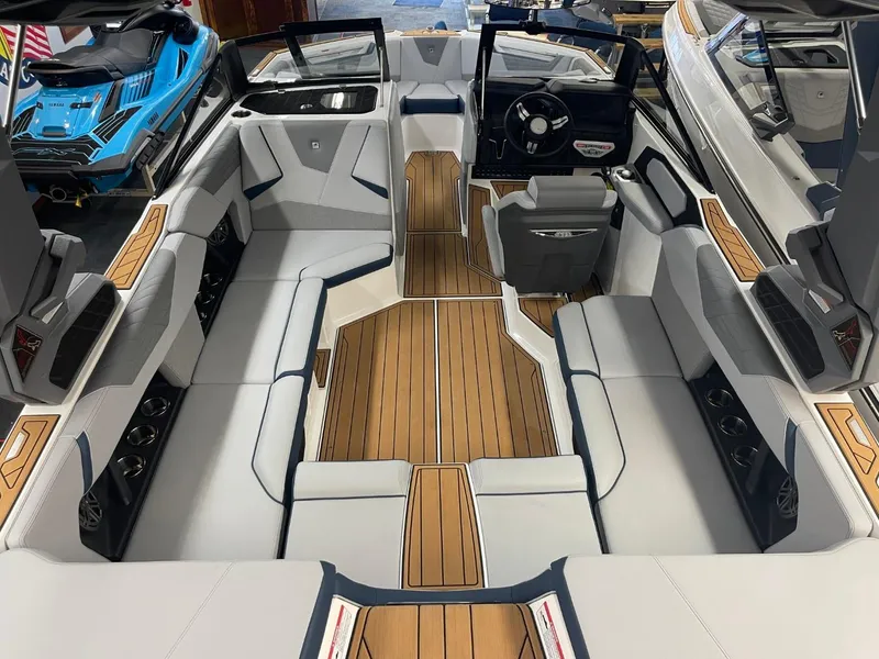 Slide: The Image of Interior of 2025 Nautique Super Air Nautique S21 with sleek seating and wood accents. - 29
