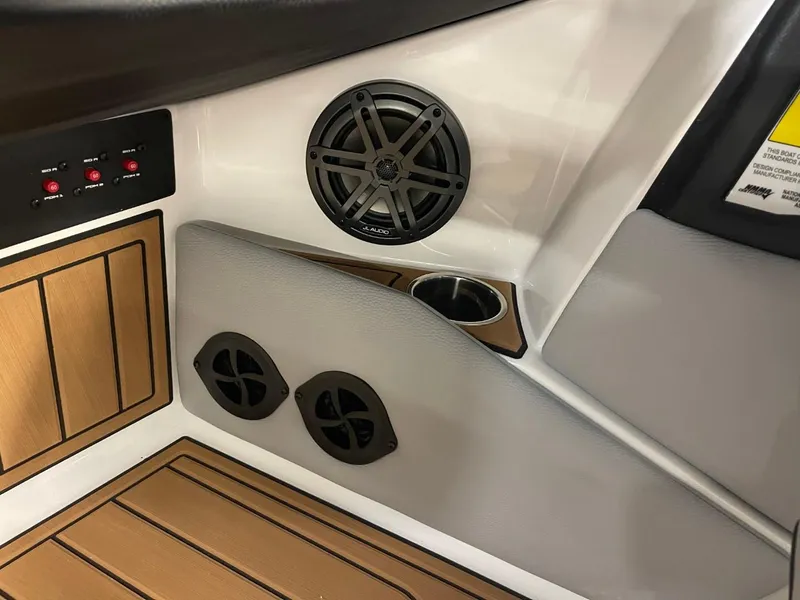 Slide: The Image of 2025 Nautique Super Air Nautique S21 interior with speaker and cup holder. - 34