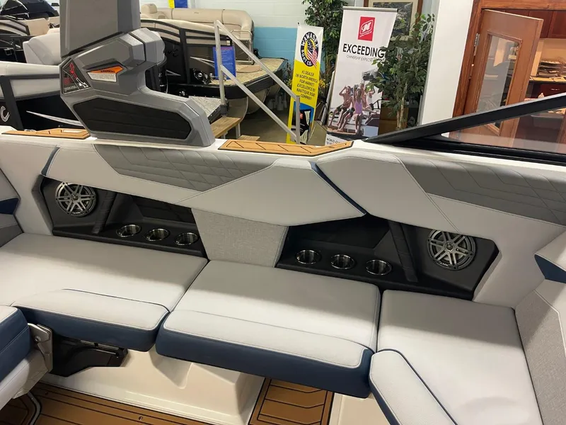 Slide: The Image of Interior of 2025 Nautique Super Air Nautique S21 boat with modern seating and speakers. - 35