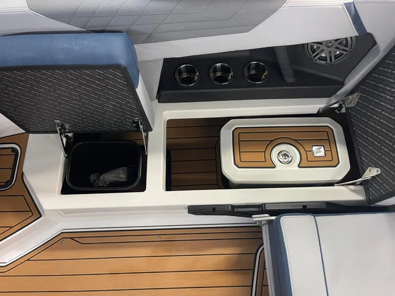 Slide: The Image of 2025 Nautique Super Air Nautique S21 interior with storage and cup holders. - 36